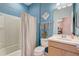 Bright blue bathroom with shower/tub combination and vanity at 9673 Sw 63Rd Loop, Ocala, FL 34481