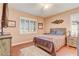 Bedroom with hard wood floors, neutral walls, and plantation shutters for ample lighting at 9673 Sw 63Rd Loop, Ocala, FL 34481