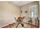 Bedroom with hardwood floors features a comfortable seating area and natural light at 9673 Sw 63Rd Loop, Ocala, FL 34481