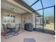 Screened lanai with outdoor furniture and ceiling fan, perfect for entertaining at 9673 Sw 63Rd Loop, Ocala, FL 34481