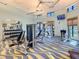 Spacious gym featuring various weight machines and equipment, with ample natural light, perfect for fitness enthusiasts at 992 Leader St, Davenport, FL 33896