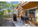 Patio space with a grill, seating, and sliding glass doors to the interior dining area at 1001 Park Ridge Cir, Kissimmee, FL 34746