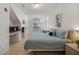 Bright bedroom featuring tile floors, a bed with blue comforter, and a desk near a large window at 1001 Park Ridge Cir, Kissimmee, FL 34746