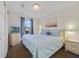 Comfortable bedroom with a large bed, soft blue linens, and plenty of natural light from the window at 1001 Park Ridge Cir, Kissimmee, FL 34746