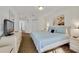 Inviting bedroom with soft blue bedding, neutral decor, and dresser at 1001 Park Ridge Cir, Kissimmee, FL 34746
