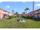 Attractive community lawn area with picnic tables, colorful condos, and manicured shrubbery at 1001 Park Ridge Cir, Kissimmee, FL 34746