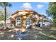 View of condo exterior featuring multiple balconies, ample shade, and a private outdoor seating area at 1001 Park Ridge Cir, Kissimmee, FL 34746