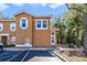 Condo exterior shows two-story facade, multiple windows with white trim, and assigned parking spaces at 1001 Park Ridge Cir, Kissimmee, FL 34746