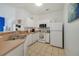 Cozy kitchen with white cabinetry, modern appliances, and a breakfast bar at 1001 Park Ridge Cir, Kissimmee, FL 34746