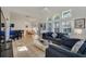 Bright living room featuring tile floors, vaulted ceilings, and comfortable seating arrangement at 1001 Park Ridge Cir, Kissimmee, FL 34746