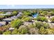 Aerial view of a community featuring lush trees and a serene lake at 10081 Cobalt Bay Rd, Orlando, FL 32827