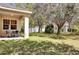 Sunny backyard with a covered patio and lush green lawn at 10081 Cobalt Bay Rd, Orlando, FL 32827