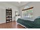 Cozy bedroom with a large window and hardwood floors at 10081 Cobalt Bay Rd, Orlando, FL 32827