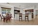 Dining area with tile floors, kitchen bar, and stainless steel refrigerator at 10081 Cobalt Bay Rd, Orlando, FL 32827