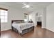 Main bedroom featuring wood floors, window views and ensuite bathroom access at 10081 Cobalt Bay Rd, Orlando, FL 32827