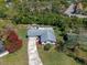 Aerial view of the home featuring a long driveway, lush landscaping, and surrounding trees at 1021 Mare Bello Dr, Winter Park, FL 32792