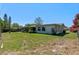 A spacious backyard with a fence, a clothesline, a patio, and ample green space at 1021 Mare Bello Dr, Winter Park, FL 32792
