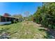 Expansive backyard with ample green space, mature landscaping, and a shed in a well-maintained yard at 1021 Mare Bello Dr, Winter Park, FL 32792
