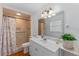 Bathroom featuring a vanity, toilet, and tiled walk-in shower at 1021 Mare Bello Dr, Winter Park, FL 32792