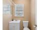 Small bathroom featuring a toilet and vanity with sink illuminated by a bright window at 1021 Mare Bello Dr, Winter Park, FL 32792