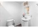 Bright half bathroom shows white fixtures, vanity and updated finishes at 1021 Mare Bello Dr, Winter Park, FL 32792