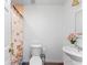 Light half bathroom with white vanity and tiled shower with glass door at 1021 Mare Bello Dr, Winter Park, FL 32792