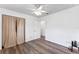 This cozy bedroom features wood-look flooring, a ceiling fan, closet, and ample natural light at 1021 Mare Bello Dr, Winter Park, FL 32792