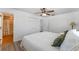 Comfortable bedroom showcasing wood floors, closet, ensuite bath, and ceiling fan at 1021 Mare Bello Dr, Winter Park, FL 32792