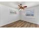 Neutral bedroom has wood-look floors, ceiling fan, and natural light at 1021 Mare Bello Dr, Winter Park, FL 32792