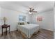 Cozy bedroom featuring a ceiling fan, windows, and a comfortable bed with decorative pillows at 1021 Mare Bello Dr, Winter Park, FL 32792