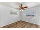 Bedroom with a ceiling fan, two windows providing natural light, and wood laminate flooring at 1021 Mare Bello Dr, Winter Park, FL 32792