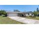 Well-kept single-story home with a two-car garage, established landscaping, and a concrete driveway at 1021 Mare Bello Dr, Winter Park, FL 32792