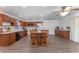 Spacious kitchen featuring an island with seating, updated appliances, and hardwood floors at 1021 Mare Bello Dr, Winter Park, FL 32792