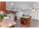 Large kitchen features a center island with bar stools, updated appliances, and hardwood floors at 1021 Mare Bello Dr, Winter Park, FL 32792