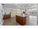 Open-concept kitchen featuring a center island with seating, hardwood flooring, and a view to the living area at 1021 Mare Bello Dr, Winter Park, FL 32792