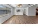 Large living room boasts a built-in shelf, ample natural light, and sleek hardwood flooring at 1021 Mare Bello Dr, Winter Park, FL 32792