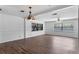 Spacious living room featuring hardwood floors, large windows and an ornate chandelier at 1021 Mare Bello Dr, Winter Park, FL 32792