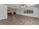 Open living space with hardwood floors, a ceiling fan, and views of the kitchen and bar area at 1021 Mare Bello Dr, Winter Park, FL 32792