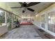 This covered patio features a ceiling fan, a barbecue, and room for relaxing at 1021 Mare Bello Dr, Winter Park, FL 32792