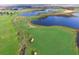 Aerial view of a lush golf course with scenic water features and pristine fairways at 1106 Kingsbarn St, Davenport, FL 33896