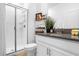 Modern bathroom featuring a glass-enclosed shower, stylish vanity, and elegant decor accents at 1106 Kingsbarn St, Davenport, FL 33896