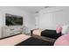 Inviting bedroom showing twin beds, soft peach accents, dresser with TV, and ample natural light at 1106 Kingsbarn St, Davenport, FL 33896