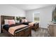 Bright bedroom with two twin beds, a wooden nightstand with plant and a TV on a dresser at 1106 Kingsbarn St, Davenport, FL 33896