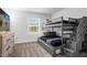 Comfortable bedroom featuring a bunk bed, dresser with TV, soft carpet and a sunlit window at 1106 Kingsbarn St, Davenport, FL 33896