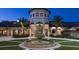 Beautiful community clubhouse featuring a grand fountain and well-manicured landscaping at 1106 Kingsbarn St, Davenport, FL 33896