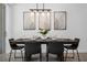 Elegant dining room with modern chandelier, stylish chairs, and artistic wall decor at 1106 Kingsbarn St, Davenport, FL 33896