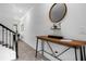 Stylish hallway featuring a wooden console table, a modern mirror, and sophisticated decor at 1106 Kingsbarn St, Davenport, FL 33896