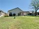 Spacious backyard featuring a well-manicured lawn, mature trees, and screened-in patios at 11624 Peach Grove Ln, Orlando, FL 32821
