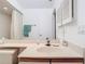 Bright bathroom featuring a single sink, vanity, and shower with white patterned shower curtain at 11624 Peach Grove Ln, Orlando, FL 32821