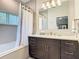 Bathroom featuring a shower with tub and a vanity with under sink cabinets at 11624 Peach Grove Ln, Orlando, FL 32821